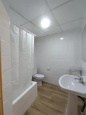 a white bathroom with a toilet and a sink at Casa Centenaria en Cortes de Pallás in Cortez de Pallas
