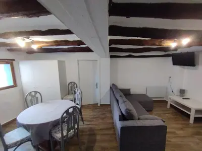 a living room with a couch and a table and chairs at Casa Rebel in Chelva