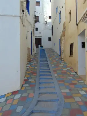 an alley with multicolored tiles on the floor at Casa Rebel in Chelva