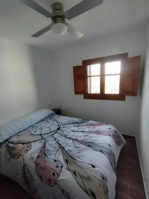 a bedroom with a bed and a ceiling fan at Casa Rebel in Chelva