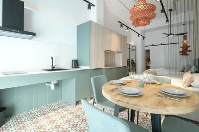 a kitchen and dining room with a wooden table and chairs at District Key - Valencia, Olimpia 2 in Valencia