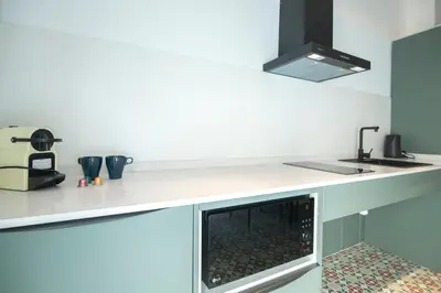 a kitchen with a counter top with a fireplace at District Key - Valencia, Olimpia 2 in Valencia