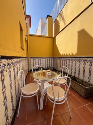 a small table and chairs on a balcony at Casa Roma in Casinos