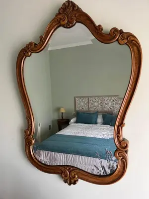 a bedroom with a large mirror on the wall at Casa Roma in Casinos