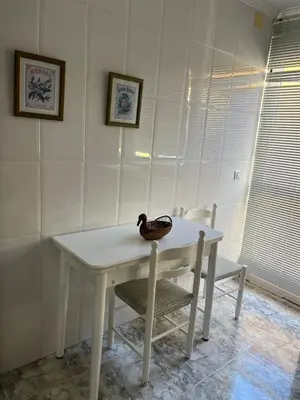 a duck sitting on a white table with two chairs at Casa Roma in Casinos
