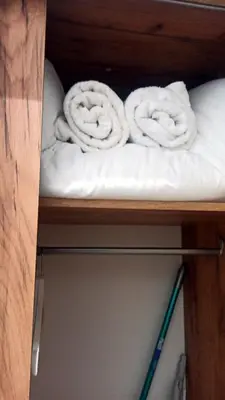 a shelf with two rolled up towels on it at Suite Guillem Jáfer - Roig Arena in Valencia