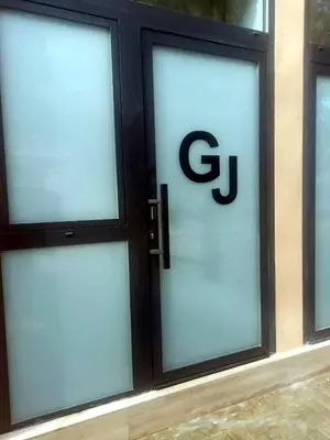 a glass door with the g logo on it at Suite Guillem Jáfer - Roig Arena in Valencia
