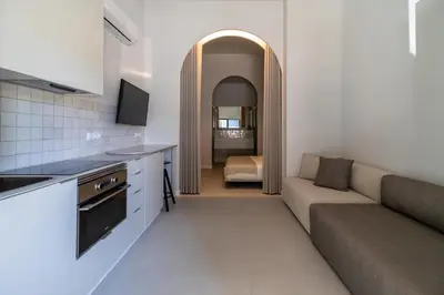 a kitchen and living room with a couch and a table at Valencia Malvarrosa point white in Valencia