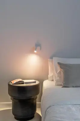 a room with a bed and a night stand next to a bed at Valencia Malvarrosa point white in Valencia