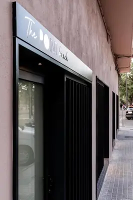 a building with a sign that reads the do hit squad at Valencia Malvarrosa point white in Valencia