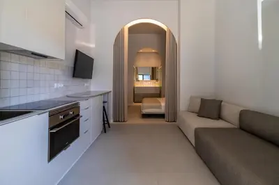 a kitchen and living room with a couch and a table at Valencia Malvarrosa point white in Valencia
