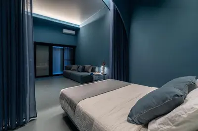 a blue bedroom with a bed and a couch at Valencia Malvarrosa beach point blue in Valencia