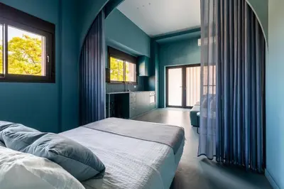 a blue bedroom with a bed and two windows at Valencia Malvarrosa beach point blue in Valencia