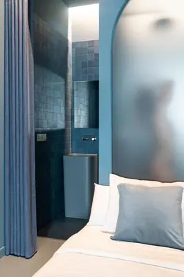 a bedroom with a bed and a bathroom with a tub at Valencia Malvarrosa beach point blue in Valencia