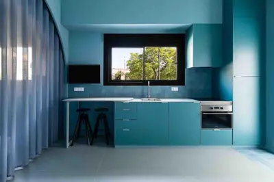 a blue kitchen with a sink and a window at Valencia Malvarrosa beach point blue in Valencia
