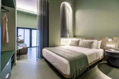 a bedroom with a large bed and a bathroom at Valencia Malvarrosa Beach point green in Valencia