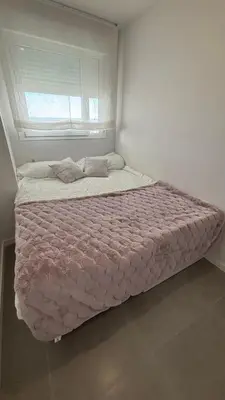 a large bed in a room with a window at Gran Canet, relax y confort a pocos pasos del mar in Canet de Berenguer