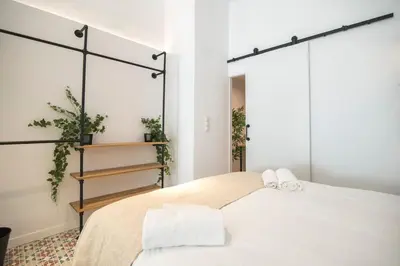 a bedroom with a bed with two towels on it at District Key - Valencia, O Arocena 1 in Valencia
