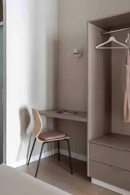 a bedroom with a desk and a chair and a closet at Valencia Malvarrosa point beige in Valencia