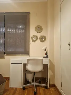 a desk with a white chair and a lamp at Les Dos Nines in Monserrat