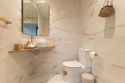 a white bathroom with a toilet and a mirror at Che Loft! Artes y Ciencias in Valencia
