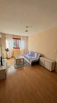 a bedroom with a bed and a table in it at Ciudad de las Artes y Arena Roig apartmento in Valencia