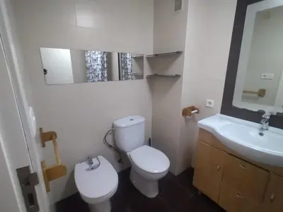 a bathroom with a white toilet and a sink at Ciudad de las Artes y Arena Roig apartmento in Valencia