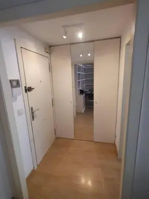 an empty hallway with white walls and a desk in a room at Ciudad de las Artes y Arena Roig apartmento in Valencia