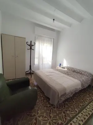 a bedroom with a bed and a chair at Apartamento Rústico in Cortez de Pallas