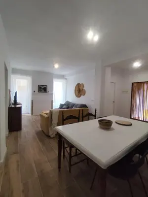a living room with a table and a couch at Apartamento Rústico in Cortez de Pallas