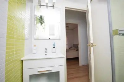 a bathroom with a white sink and a mirror at Lujoso Apartamento en Valencia 3 Dormitorios con Parking in Paterna