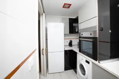 a kitchen with a refrigerator and a washer and dryer at Lujoso Apartamento en Valencia 3 Dormitorios con Parking in Paterna