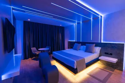 a bedroom with a bed and a table and chairs at Motel JOC in Valencia