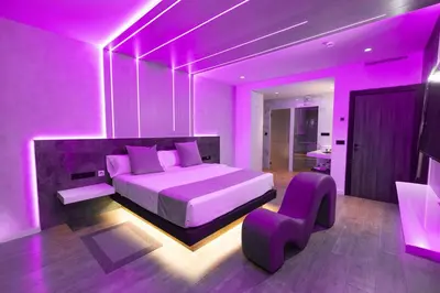 a purple bedroom with a bed and a chair at Motel JOC in Valencia