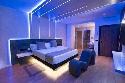 a bedroom with a bed and a chair in it at Motel JOC in Valencia