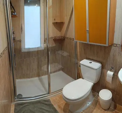 a bathroom with a toilet and a shower at Cozy townhouse in Soneja in Soneja