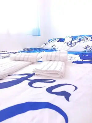 a bedroom with a bed with blue and white sheets at Cozy townhouse in Soneja in Soneja