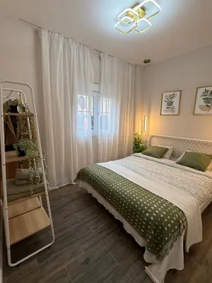 a bedroom with a bed with a green and white blanket at Urban Soul Studio in Valencia