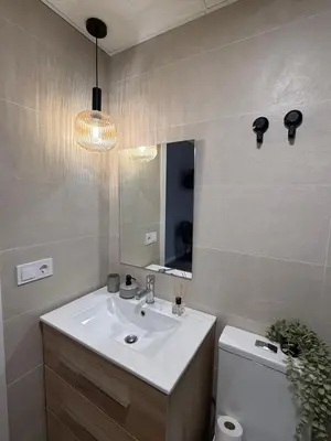 a bathroom with a sink and a mirror and a toilet at Urban Soul Studio in Valencia