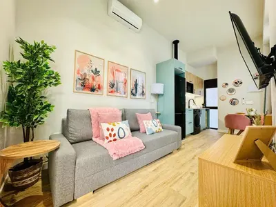a living room with a gray couch and a table at Bright & Stylish Flat Close To Center in Valencia