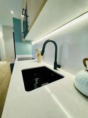 a kitchen counter with a sink and a sink at Bright & Stylish Flat Close To Center in Valencia