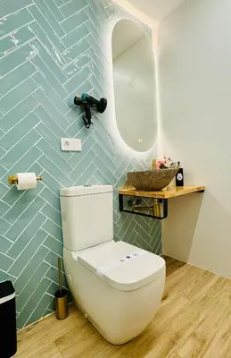 a bathroom with a toilet and a mirror at Bright & Stylish Flat Close To Center in Valencia