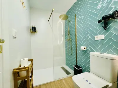 a bathroom with a toilet and a shower at Bright & Stylish Flat Close To Center in Valencia