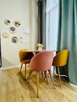 a dining room with a table and four chairs at Bright & Stylish Flat Close To Center in Valencia