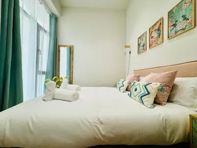 a bedroom with a large white bed with pillows at Bright & Stylish Flat Close To Center in Valencia