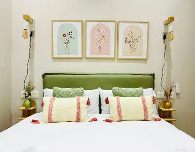 a bedroom with a white bed with three pictures on the wall at Cozy & Stylish Loft near City Center in Valencia