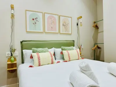 a bedroom with a large white bed with pillows at Cozy & Stylish Loft near City Center in Valencia
