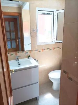 a bathroom with a sink and a toilet at El Cabañal 400 meters from the Beach in Valencia