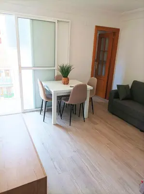 a living room with a white table and chairs at El Cabañal 400 meters from the Beach in Valencia