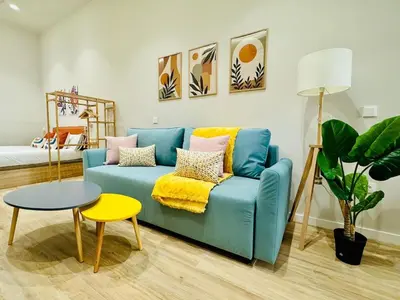 a living room with a blue couch and a table at Stylish Studio near City Center in Valencia